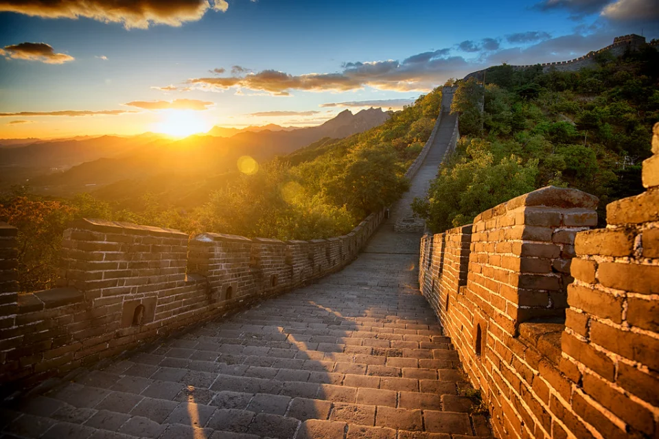 The Great Wall of China at sunset with golden skies in Jinshanling
