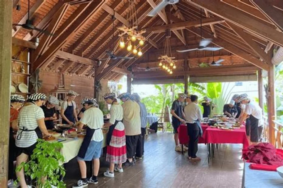 Tourists learning Khmer recipes in a Siem Reap cooking class