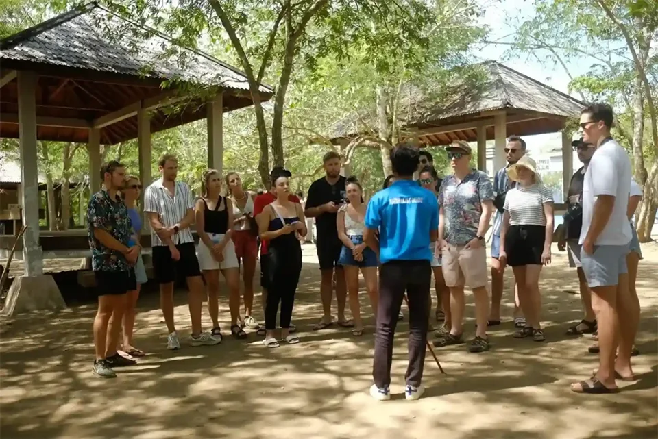 A Komodo National Park ranger explaining safety and conservation rules to tourists
