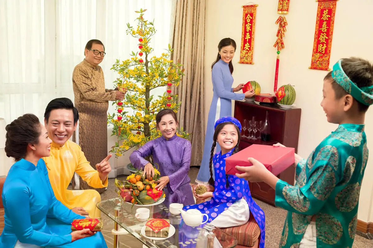 Vietnamese family celebrating Lunar New Year with traditional Tet decorations