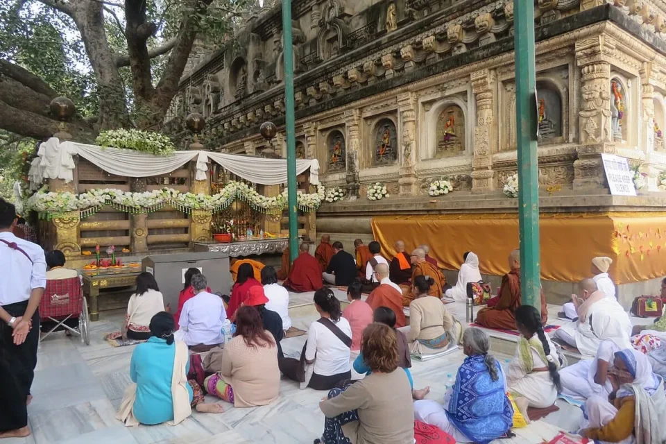 Pilgrims meditating at Mahabodhi Temple in Bodh Gaya, India