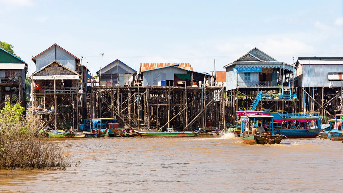 Stilt houses rising high above water in Kampong Phluk floating village, Cambodia