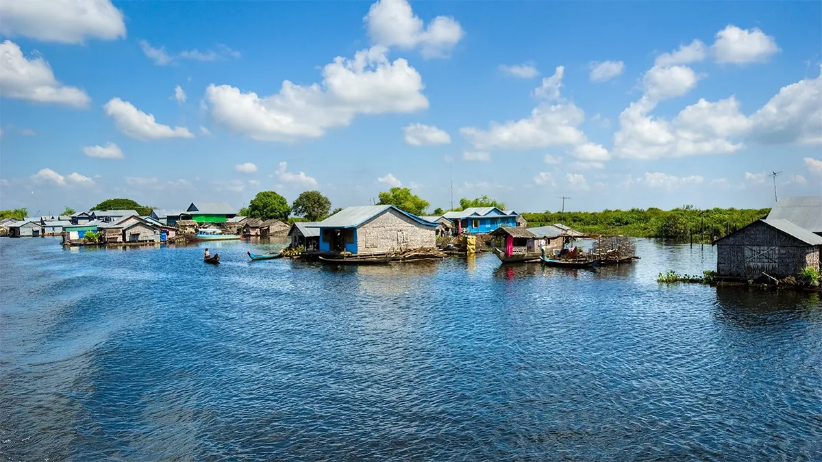 A wide view of Tonle Sap floating village with wooden houses and boats on the lake