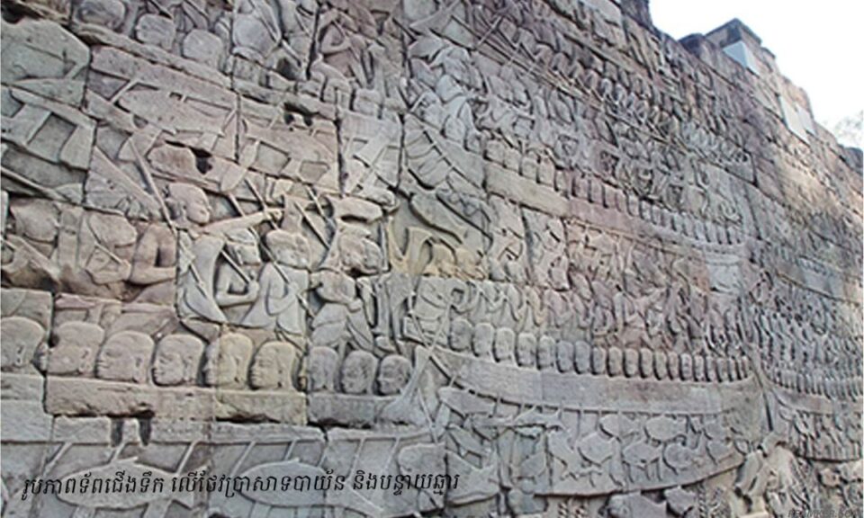 Ancient bas-relief carving on Bayon temple showing Khmer naval warriors in longboats, illustrating the historical roots of Bon Om Touk