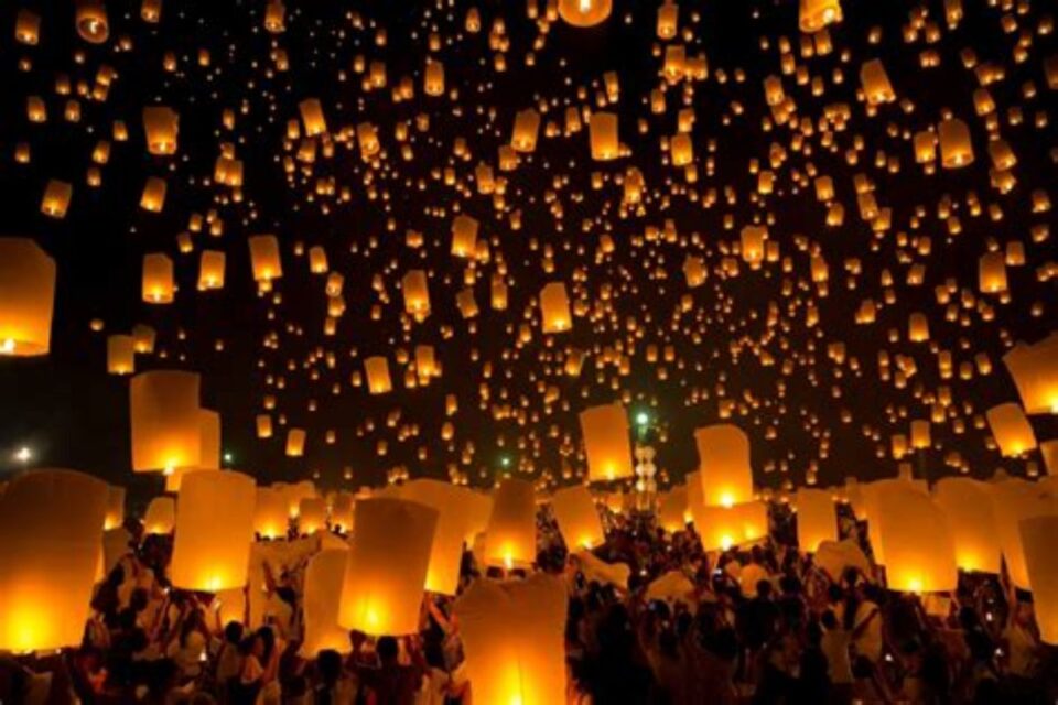 Thousands of sky lanterns lighting up the Chiang Mai night sky during Yi Peng and Loy Krathong Festival.