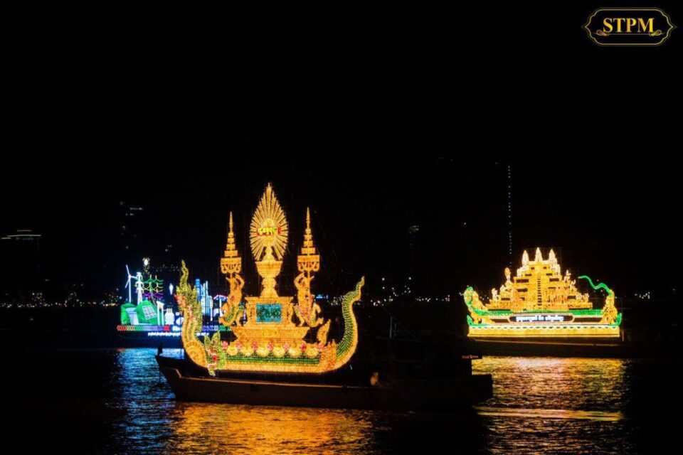 Illuminated boats glowing at night during Bon Om Touk in Cambodia.