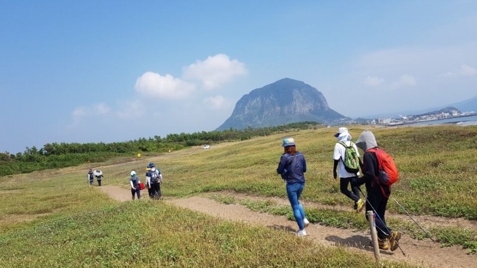 Jeju Olle Walking Festival 2025 scenic coastal trail with walkers on Jeju Island