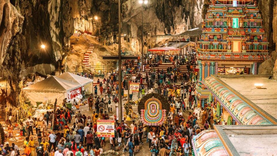 Large crowd of devotees at the colorful stairs of Batu Caves during the Thaipusam 2026 festival.