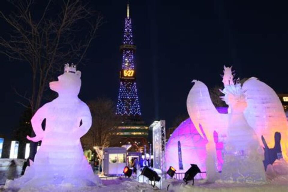 Giant lit-up snow sculpture at Odori Park Sapporo at night.
